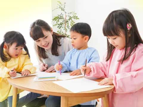 a group of children sitting around a table