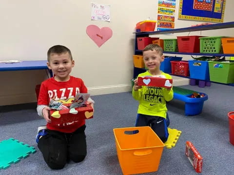 two boys sitting on the floor