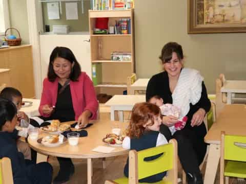 a group of people sitting around a table with food