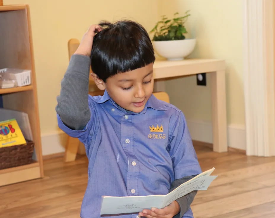 a young boy reading a book