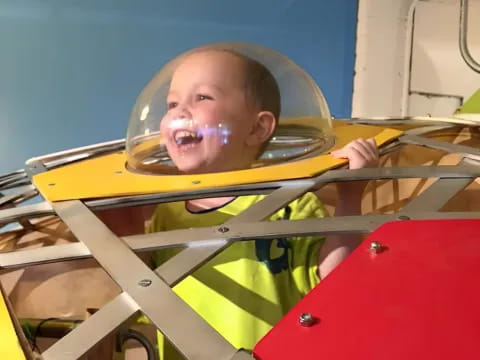 a baby in a yellow safety vest