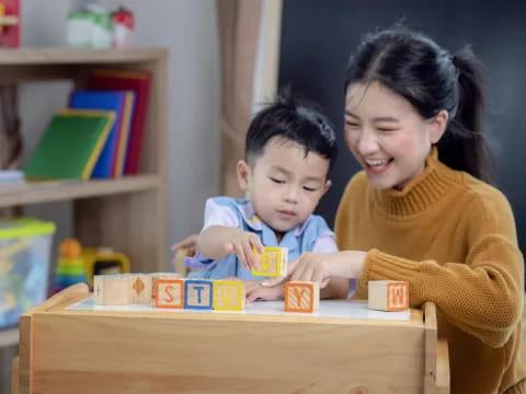 a person and a child playing with a toy