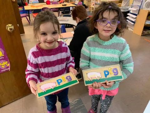 a couple of girls holding books