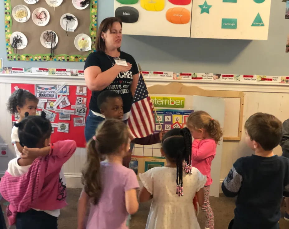 a person standing in front of a group of children