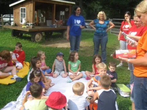 a group of children sitting on the grass