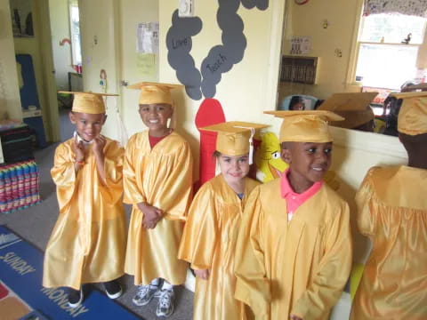 a group of children wearing yellow robes
