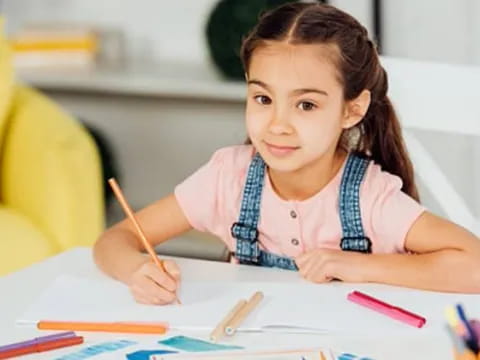 a young girl sitting at a table