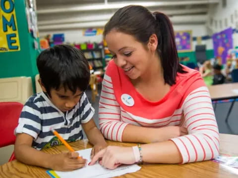 a person and a child sitting at a table