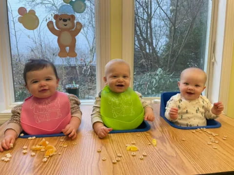 a group of babies sitting on the floor