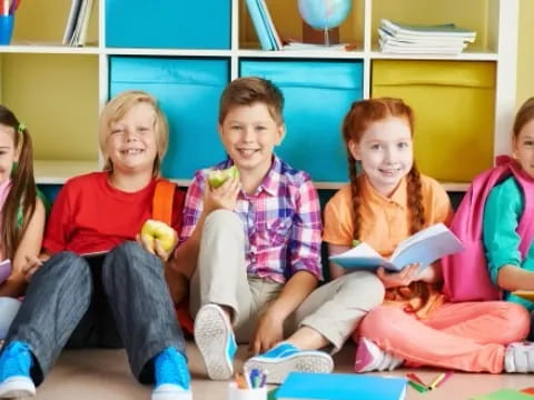 a group of children sitting on a couch and smiling