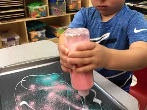 a child holding a plastic toy