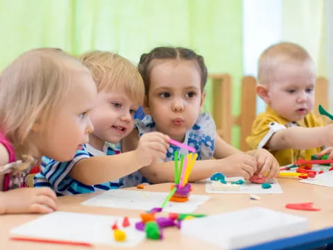 a group of children sitting at a table