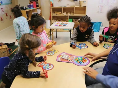 a group of children sitting around a table