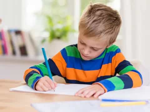 a child writing on a book