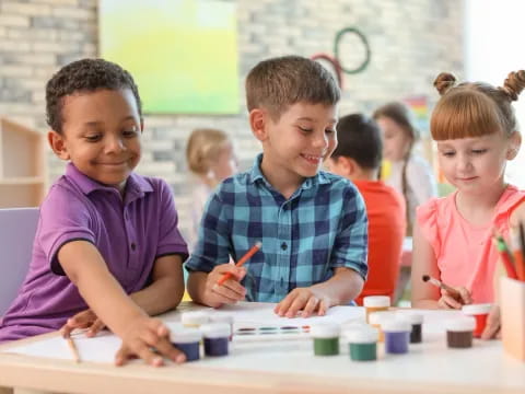 a group of children sitting at a table