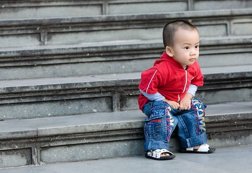 a baby sitting on steps