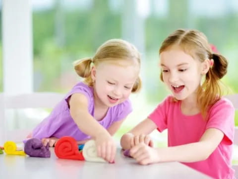 a couple of girls playing with toys