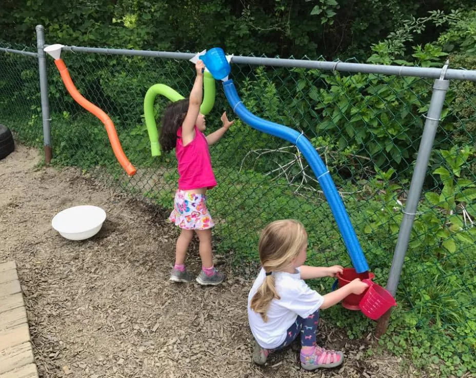 two girls playing with a toy