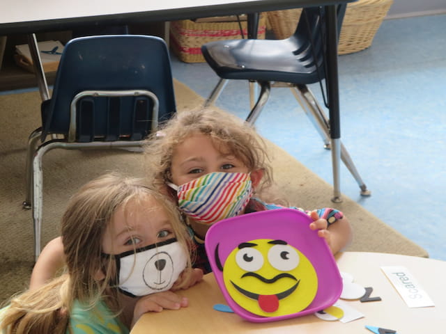 a couple of girls with a toy