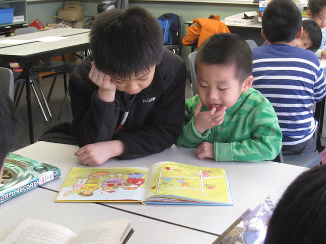 a few children sitting at a table