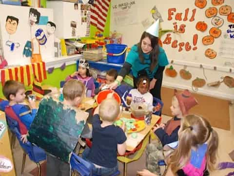 a person and several children in a classroom