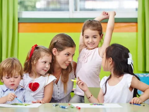 a group of children sitting at a table