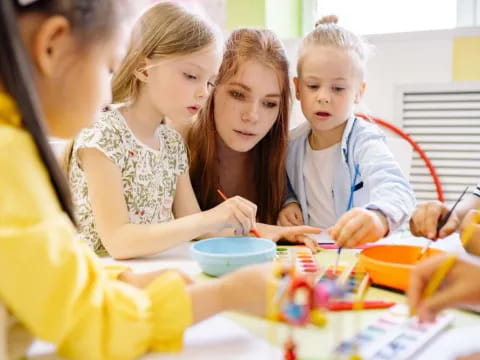 a group of children sitting at a table