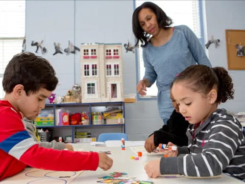 a person and children sitting at a table