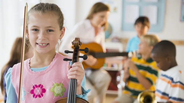 a young girl playing a violin