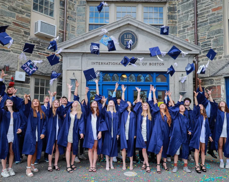 a group of girls in blue graduation gowns and caps