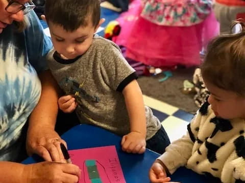 a person and a child sitting at a table