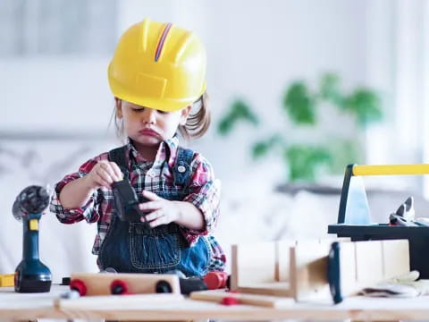 a young girl wearing a hard hat