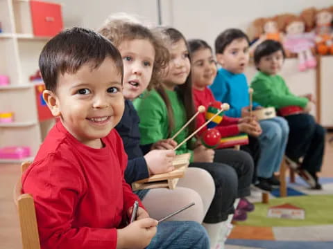 a group of children sitting in a classroom