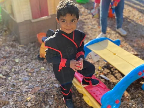 a boy holding a toy