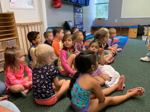 a group of children sitting on the floor