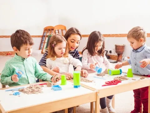 a group of children sitting around a table