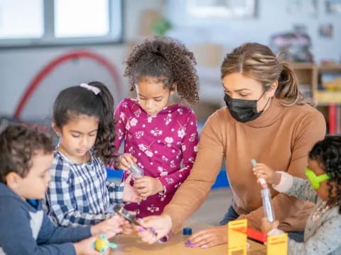 a teacher helping her students