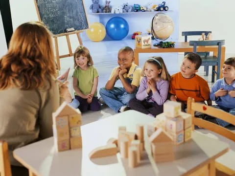 a group of children sitting around a table