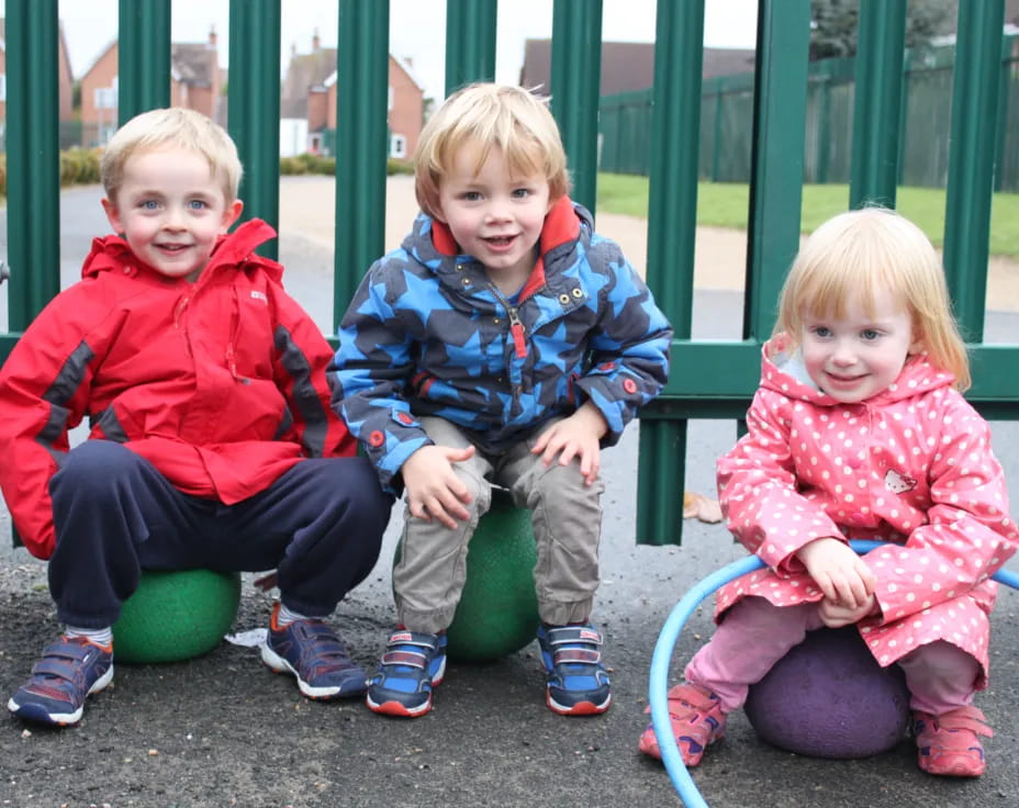 a group of children sitting on a bench