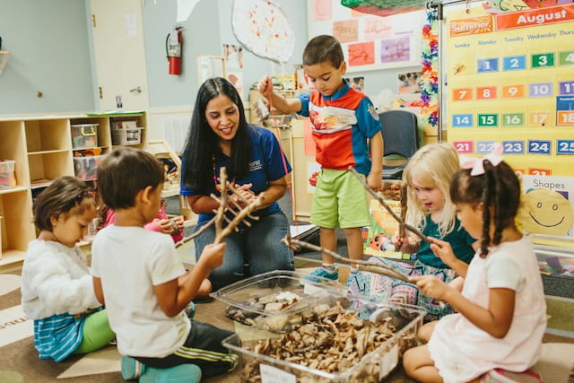 a person and children in a classroom