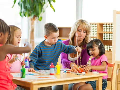 a group of children sitting at a table