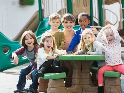 a group of children sitting at a table