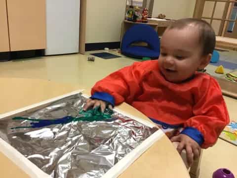 a baby playing with plastic