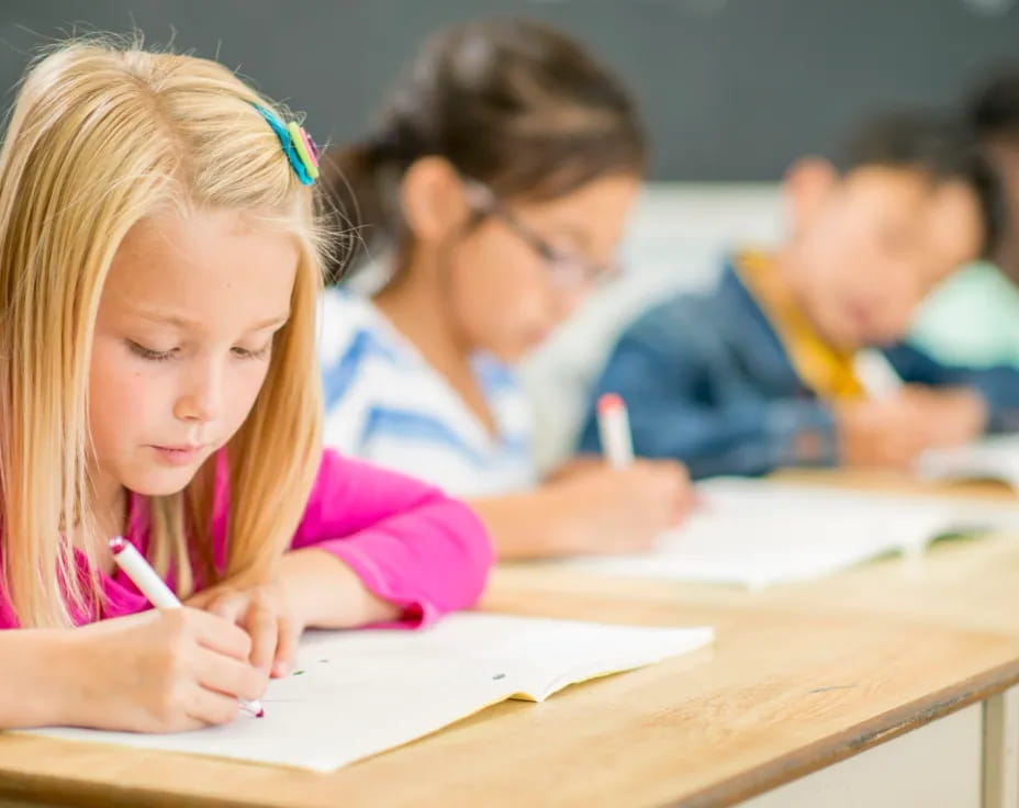 a girl writing on a book