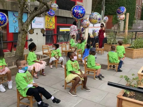 a group of children sitting in chairs