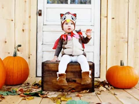 a baby sitting on a wooden box