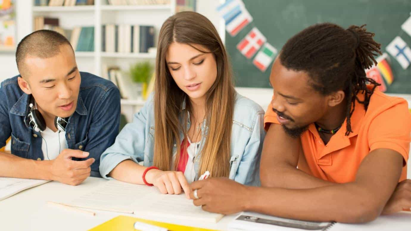 a group of people looking at a paper