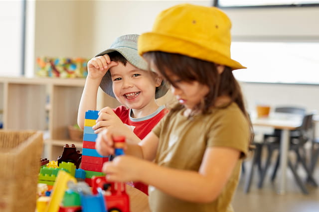 a person and a child playing with toys