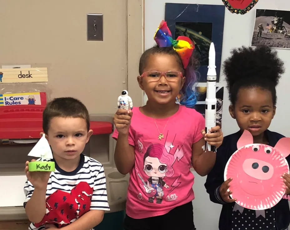 a group of children holding toys