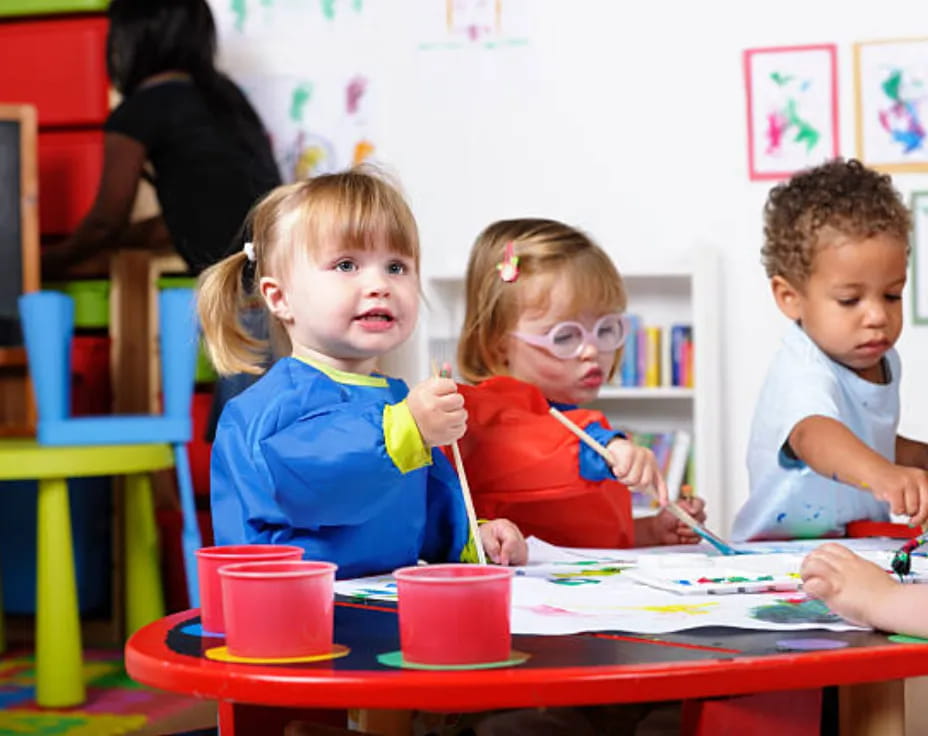 a group of children sitting at a table